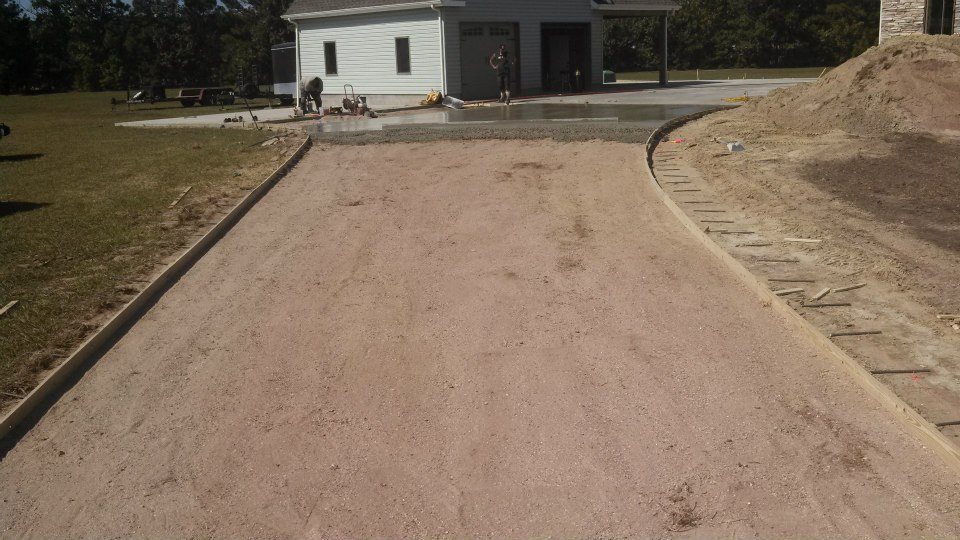 Curved broom finished driveway with stamped border & apron (before)
